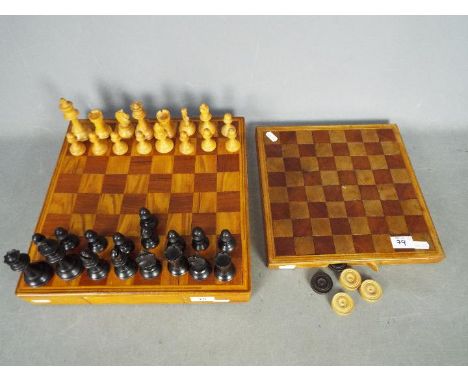 A wooden chess set and board, 9.5 cm king and a draughts board and pieces. [2]