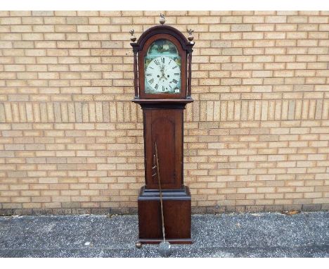 An early 19th century oak and mahogany cased 8-day longcase clock, arched hood surmounted by eagle and ball brass finials, fl