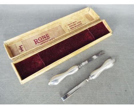 Two silver handled nail care tools, boxed