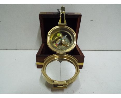 Saltney London - Compass (Brass). Fitted wooden box with brass inlay, anchor design on top. Box is 9.5cm wide.