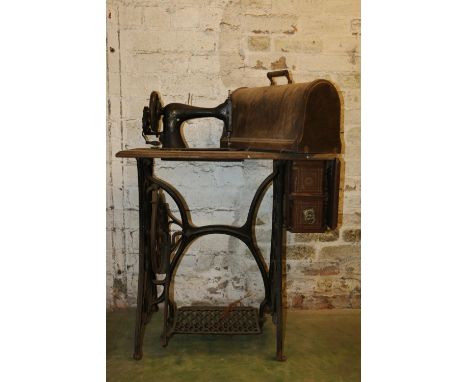 Vintage Singer sewing machine on treadle base. 