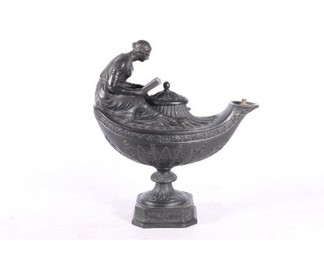 Wedgwood black basalt oil lamp in the form of an Aladdin lamp with figure reading surmount, 23cm tall.  Cracks visible from u