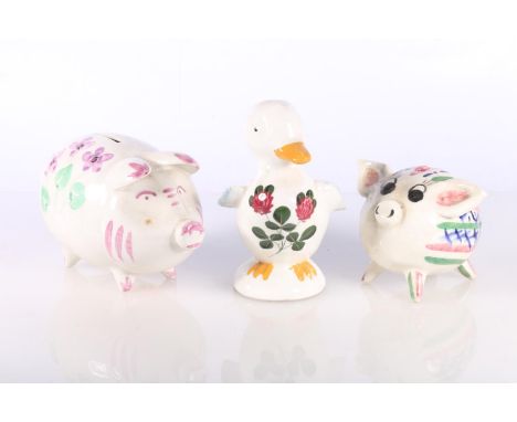 Plichta pottery model of duck and two hand-painted pottery piggy banks.&nbsp; (2) 