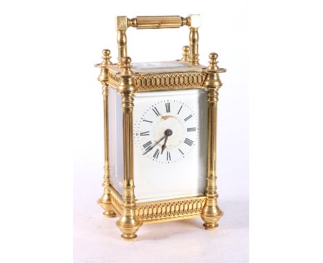 French gilded brass carriage clock, the white enamel dial with Roman numerals, 16cm tall. No key present.  Clock face badly m