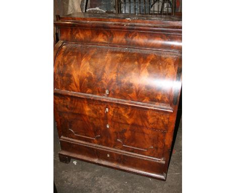 Antique flame mahogany veneered cylinder bureau with fully fitted interior including drawers, tabernacle cupboard, etc., rais