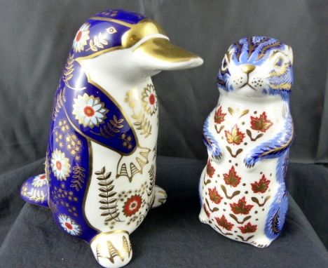 Two Royal Crown Derby paperweights; silver stopper Guinea Pig and a Duck Billed Platypus