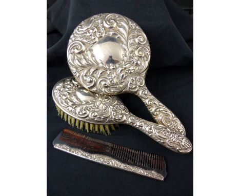 Hallmarked silver three piece dressing table mirror, brush and comb set. Assay marks present but rubbed