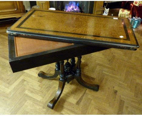 Burr walnut and ebony fold over games table with two drawers on a four pillard support with swept legs on ceramic castors 99 