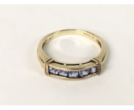 A 9ct Gold ring with a row of gemstones, 2.8g. Ring size Q.5