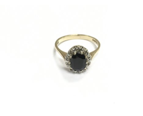 A 9ct gold ring set with small diamonds and sapphire coloured stones, approx 2.7g and approx size N-O.