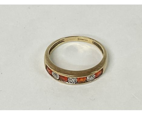 A 9ct Gold ring with a row of gemstones. 2.4g Q