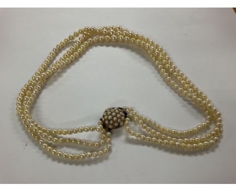 A 3 string pearl necklace with a 9ct gold and seed pearl clasp.