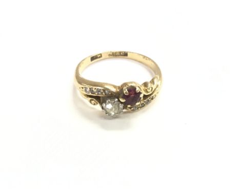 An 18ct gold ruby and diamond crossover ring. Size approximately J and weight 2.9g.