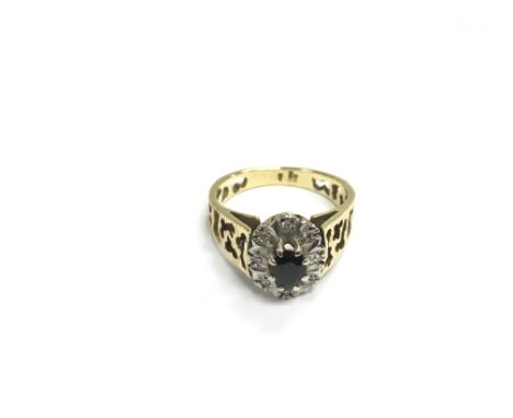 An 18ct gold ring set with a central sapphire surrounded by diamonds, approx 5.5g and approx size P-Q.