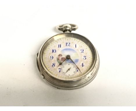 A very ornate silver ladies pocket watch with enamel face. Winds and runs.