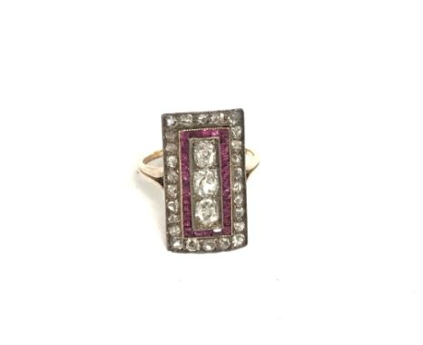 A cocktail ring inset with three diamonds square cut rubies and then further diamonds. Size J.