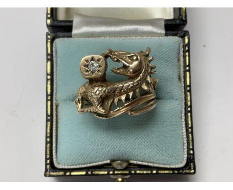 A 9ct gold ring in the form of a dragon inset with a single solitaire diamond. Ring size Q.