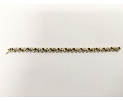 An 18ct gold, sapphire and diamond line bracelet, approx 28.3g.