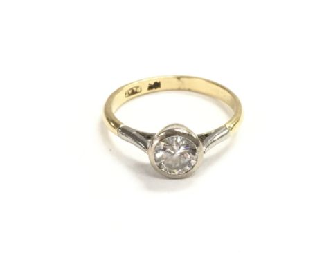 An 18ct gold and platinum ring set with approximately half carrat diamond. Size K and weight is 2.77g.