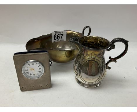 A small Victorian hallmarked silver floral embossed cream jug with Sheffield hallmarks together with a hallmarked silver sauc