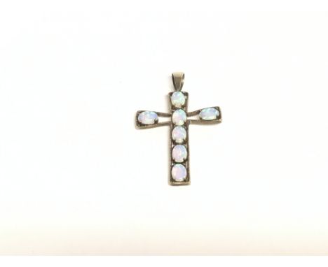 A 9ct gold cross set with 7 Opal gems.