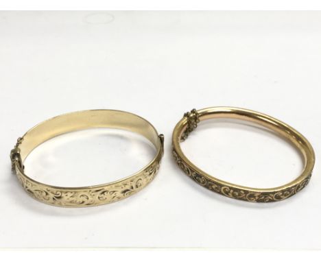 A rolled gold bangle and one other unmarked bangle (2).