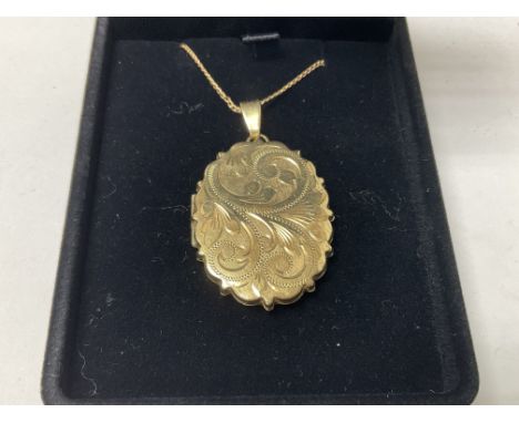A 9ct gold engraved locket. Approx 9.9g.