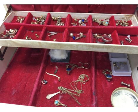 A jewellery box containing various sets of earrings together with a 9 ct gold bracelet.