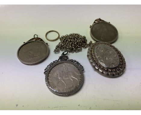 A hallmarked silver locket and chain together with 3 silver mounted coins and an eternity ring.