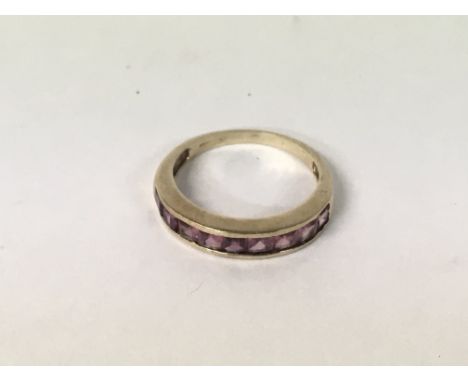 A 9ct gold ring with a row of gemstones 2.8g, P.5.