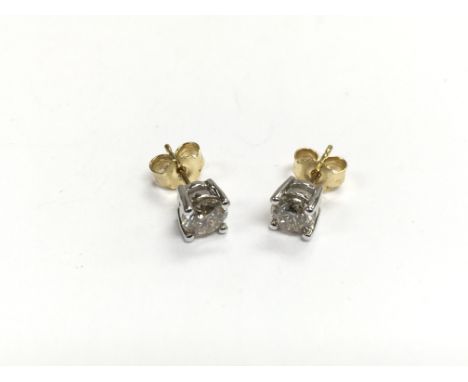 A pair of white gold studs set with diamonds and with 18ct yellow gold backs, approx 2g.
