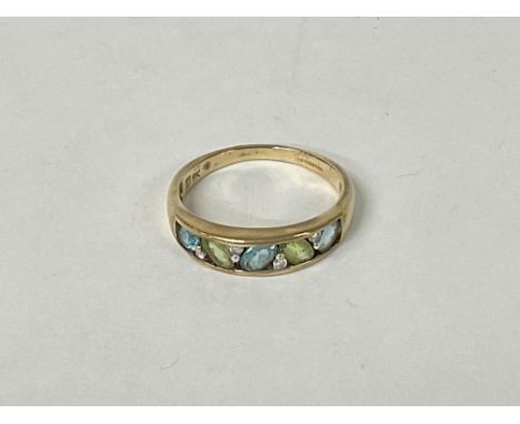 A 9ct Gold ring with a row of gemstones. 2.5g P.5