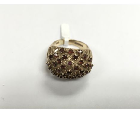 A 9ct gold dome ring set with garnets, approx 7.6g and approx size M-N.