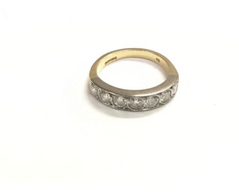 An 18ct gold and platinum ring set with a row of seven diamonds each of which are approximately 0.15ct. Size N and weight 4.8