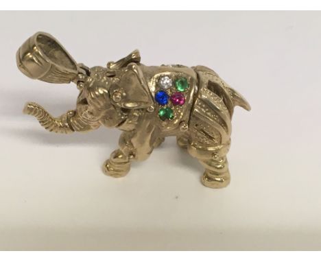 A 9 ct gold elephant pendant with gem stone inset . 25 grams