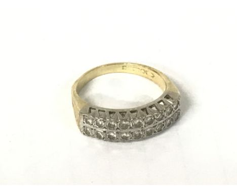 A gold ring with worn hallmarks with two rows of diamonds, size O/P 4.9g