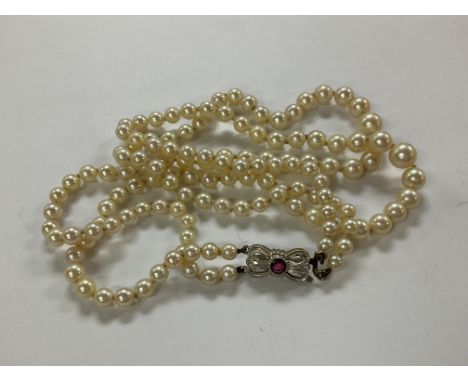 A double string of pearls with an 18ct gold diamond and seed pearl necklace.