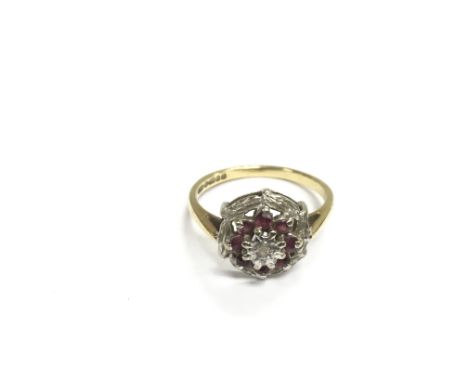 An 18ct gold ring set with rubies and small diamonds, approx 3.7g.