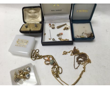 A collection of earrings and gold plated chains .