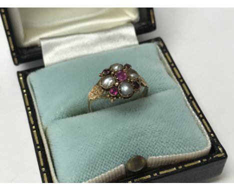 An antique 15ct yellow gold and half cut seed Pearl and ruby ring, size G.