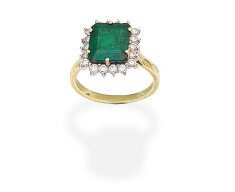 EMERALD AND DIAMOND CLUSTER RINGThe step-cut emerald within a brilliant-cut diamond surround, mounted in 18 carat gold, Londo