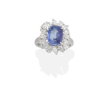 SAPPHIRE AND DIAMOND CLUSTER RINGThe cushion-shaped sapphire, within a marquise-cut and pear-shaped diamond surround, between