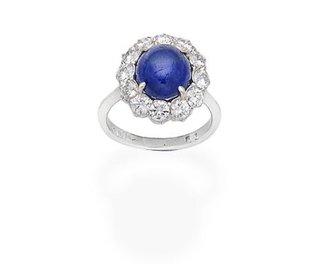 SAPPHIRE AND DIAMOND CLUSTER RINGThe cabochon sapphire within a brilliant-cut diamond surround,  diamonds approx. 1.20cts tot