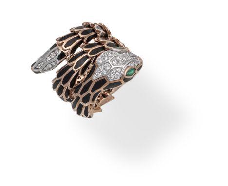 BLACK ENAMEL AND GEM-SET SNAKE RINGDesigned as a coiled snake with sprung structure, the body decorated with black enamel, th
