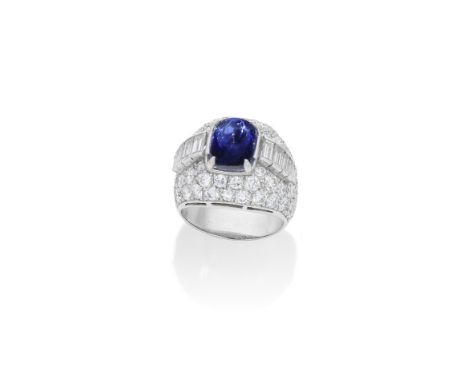 SAPPHIRE AND DIAMOND DRESS RINGThe sugarloaf sapphire weighing 7.09 carats, between baguette-cut diamond shoulders, in a bomb