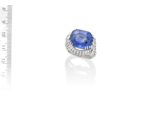 SAPPHIRE AND DIAMOND RING,  CIRCA 1950The octagonal step-cut sapphire, weighing 19.33 carats, between brilliant-cut diamond a