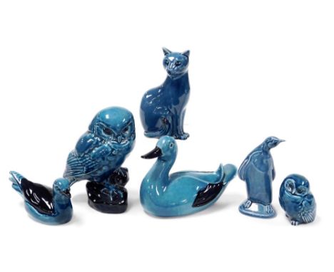 A group of six Poole blue glazed pottery figures of birds, including a penguin and two owls, together with a seated figure of
