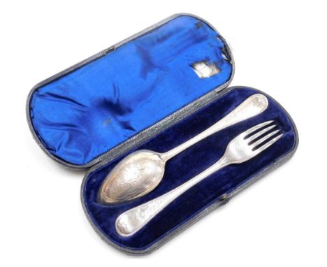 A Victorian silver fork and spoon, with engraved floral and engine turned decoration, cased, maker's mark worn, London 1866, 