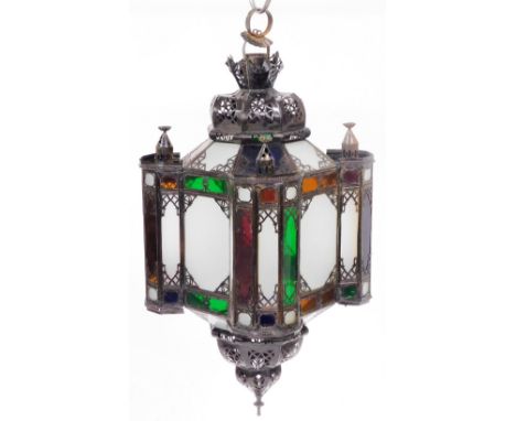A Moroccan tin and glass hanging lantern, of mosque form, 82cm high.