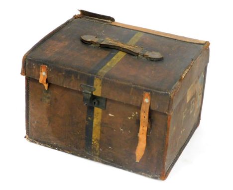 An early 20thC vintage leather trunk, bearing travel labels and initials FB, 34cm high, 52cm wide, 44cm deep.